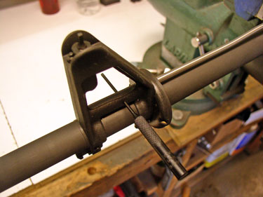 Use a punch to align the hole in the gas tube with the hole in the gas block. Then tap in the roll pin to retain the tube.