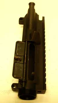 The proper alignment of the cover spring, with the short leg touching the port, and the long leg lying in a groove on the inside surface of the cover. It’s important that this step is completed before attempting to install the barrel.