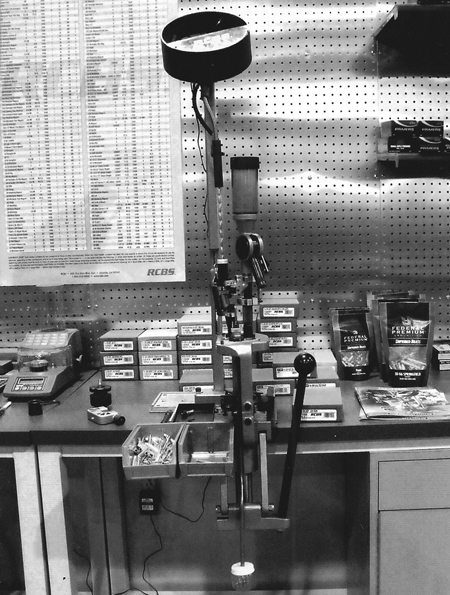 The RCBS Bullet Feeder set up on the RCBS progressive loading press. It feeds the bullets, base down, directly into the feeding tube, ready to be dropped into the case mouth.