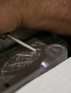 A sharp engraving tool produces a curl as the tool cuts the steel.