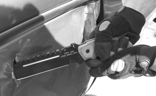 Tops Steel Eagle cutting into car door panel. A very useful tool in times of need. ©ML Ayres.