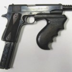 John Dillinger's 1911 converted to full auto and .38 Super, complete with a Thompson submachine gun forearm.