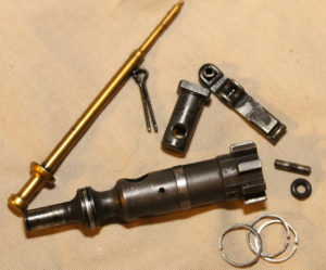The spares you might be able to use in an emergency, or without extensive tools. A complete bolt, extra extractor, pin and o ring. Firing pin, cotter pin, gas rings.