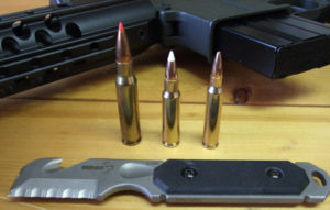 DSCF1007(2) The 6.8 fits well ballistically between the 7.62mm NATO (shown with 110 gr. Hornady TAP) on left, and 77gr. Wilson Combat 5.55mm BTHP on right. The 6.8 has a 110 Gr. Nosler Ballistic Tip bullet from Silver State Armory. The ammo is shown with the 6.8 Recon Rifle and Wilson Combat COP Tool.