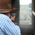 Cowboy Action competitions often demand precise shots, such as this one where a competitor attempts to hit a target through two doorways.