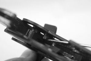 The pin projection on the inside of the right triggerguard arm should be behind the tab on the bottom of the hammer. This pin cocks the hammer when the trigger guard is pulled down.