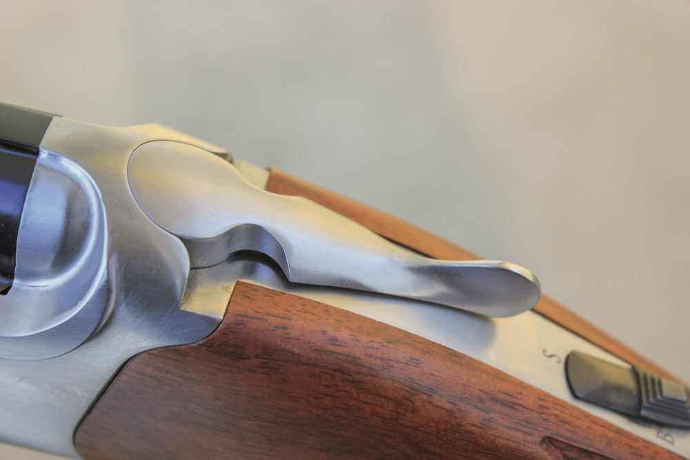 The safety on the Red Label is automatic, every time the action is opened the lever automatically slides back to the safe position.
