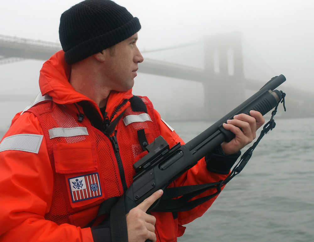 Remington-870-Coast-Guard A U.S. Coast Guard petty officer from Maritime Safety and Security Team 91106 armed with an M870P fitted with a Trijicon reflex sight and a Speedfeed stock.