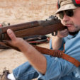 In sitting position with support forearm wrapped around sling and hand between sling and stock and wedged against front swivel.
