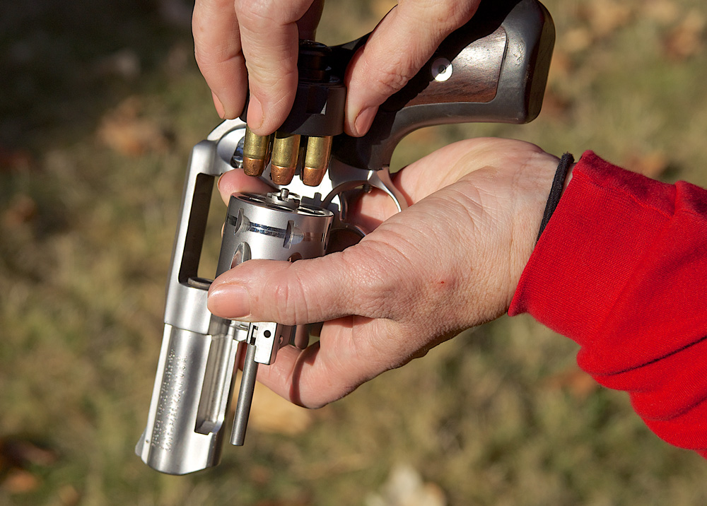 As you bring the hand with the speedloader toward the one that is holding the cylinder, the speedloader will naturally end up over the chambers.
