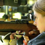 A practiced off-hand target competitor. Her rifle is just that, a rifle.