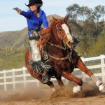 With guns a blazing, Kenda Lenseigne puts her horse through its paces.