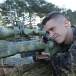 A Marine hugs his M40 sniper rifle--and he's probably shooting at something beyond 53 yards.